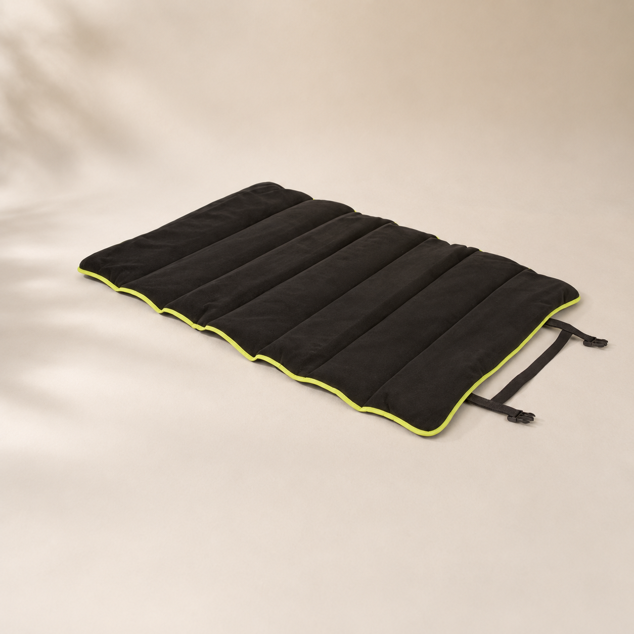 3 Peaks Roll Up Travel Dog Mat laid flat, showing black fleece channels, lime trim and fastening straps