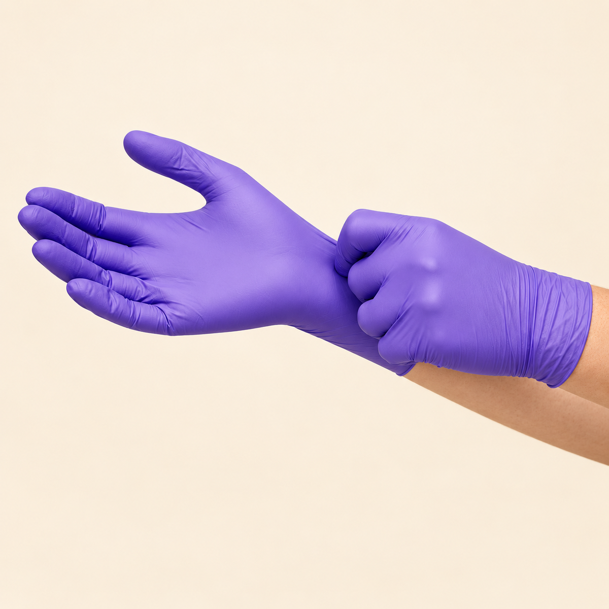 Hands putting on purple nitrile gloves, showing the fit and cuff