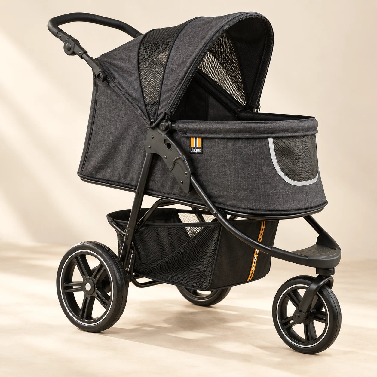My Duque COOPER dog stroller open in a charcoal-grey studio view