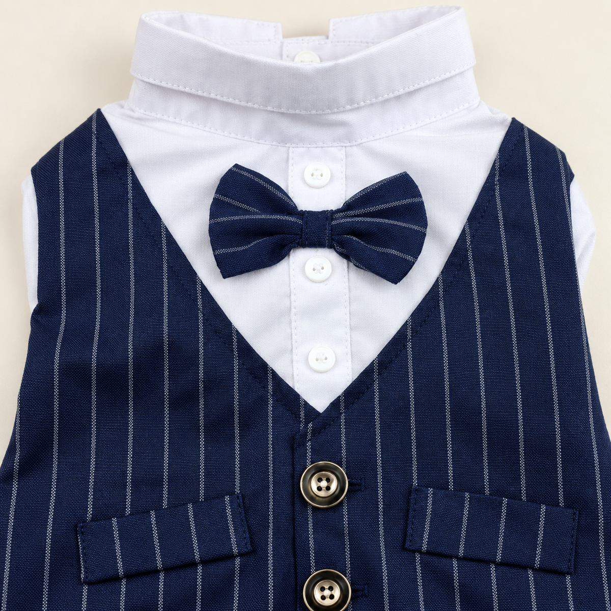 Close-up of the navy pinstripe bow tie, white shirt front and two waistcoat buttons