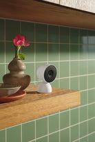 Google Nest Cam Indoor wired 3rd generation on a home shelf