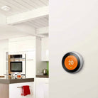 Google Nest Learning Thermostat 3rd generation mounted in a kitchen