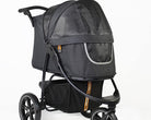 Loui in the spacious My Duque COOPER dog pram with large wheels and storage for mobility trips